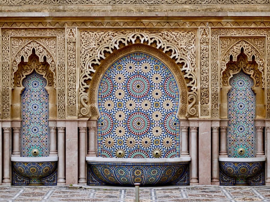 Hand-cut zellij tilework and carved stucco around a Moroccan fountain